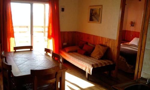 a living room with a couch and a window at Cabañas del Rio - La Pesca - Region del Maule in Iloca