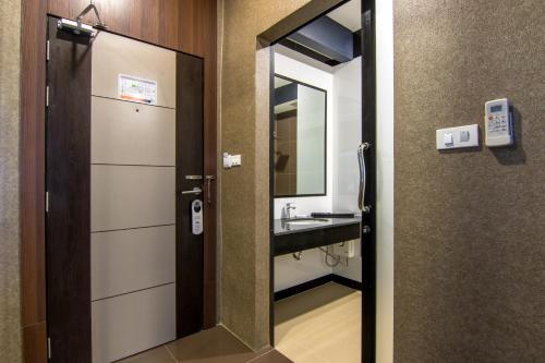 a bathroom with a sink and a mirror at PSG Hotel in Udon Thani