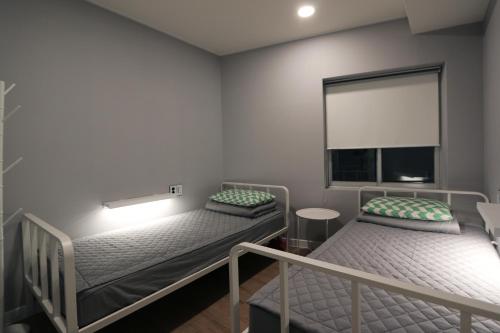 Katil atau katil-katil dalam bilik di Blueboat Hostel Haeundae