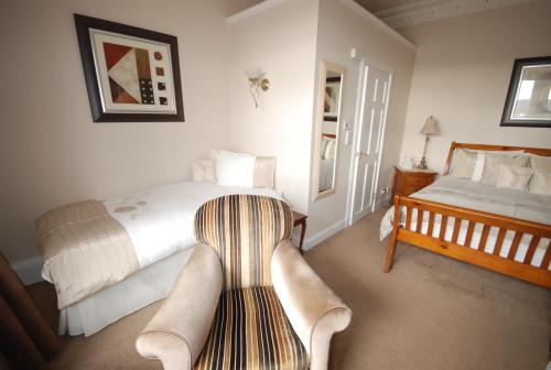 a bedroom with a bed and a couch in it at Gramarcy House in Brechin