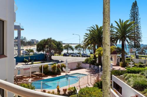 vista su un resort con piscina e palme di Alex Headland Beachfront ad Alexandra Headland
