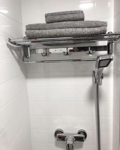 a bathroom with a towel rack and towels at Hang Fung Hostel in Hong Kong