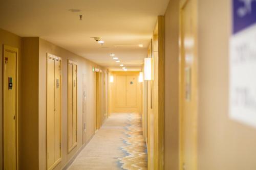 a long hallway with shells on the floor of a room at ibis Styles Changsha Intl Exhibition Ctr in Huangxing