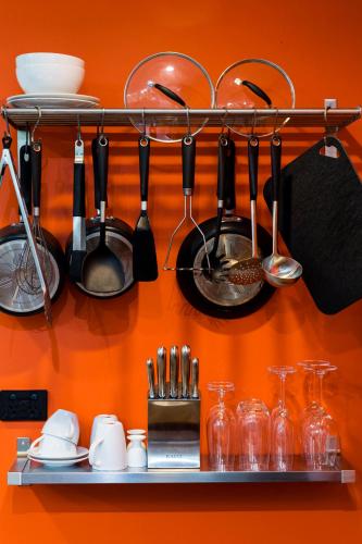 a shelf with utensils and utensils on a wall at Dairyman's Cottage in Lyndoch