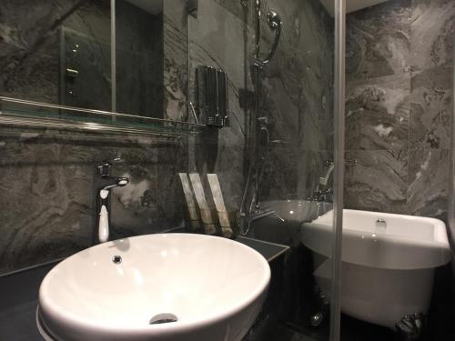 a bathroom with a white sink and a shower at Ueno Hirokoji 428 in Taipei