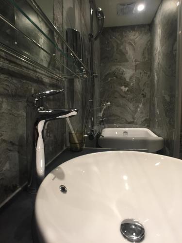 a bathroom with a white sink and a faucet at Ueno Hirokoji 428 in Taipei