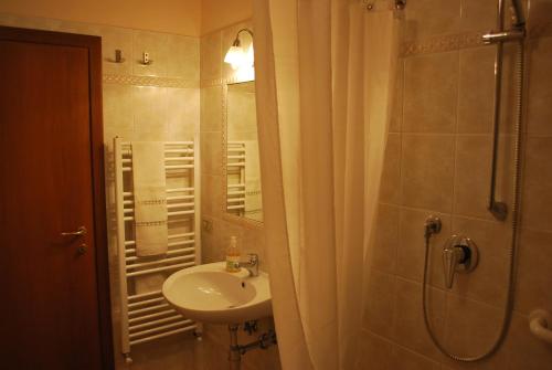 a bathroom with a sink and a shower with a mirror at Casa S.Maria in Levane