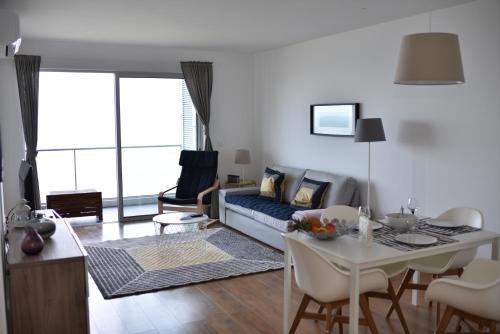 a living room with a couch and a table at Xenon Urban Apartments in Maputo