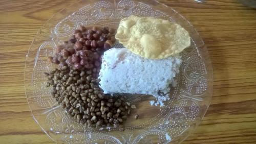 a glass plate with different types of food on a table at Munroe Coconut Homestay in Munroe Island