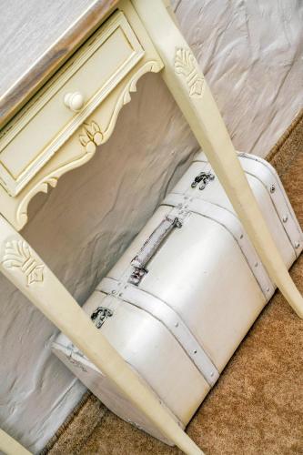 a white barrel laying on the floor next to a table at Feniks Agro&Spa Adults Only in Świnoujście