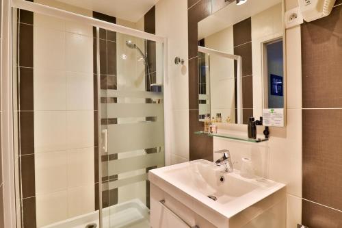 a bathroom with a sink and a shower at Hotel La Tuiliere in Carry-le-Rouet