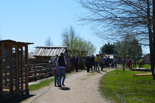 a group of people walking down a dirt path at Atpūtas vieta Buki in Ventspils