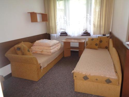a small room with a bed and a couch at OW Inter Piast Kalbornia - z własną plażą z kąpieliskiem i przystanią in Dąbrówno