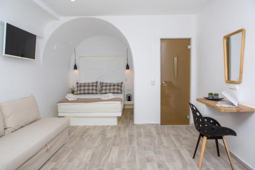 a living room with a couch and a chair at Korali Hotel in Naxos Chora