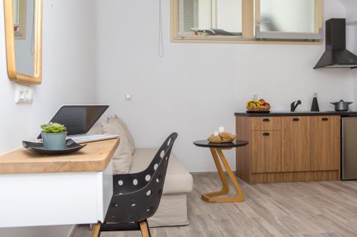 a kitchen and living room with a table and a laptop at Korali Hotel in Naxos Chora