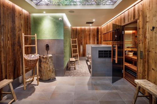 a kitchen with wooden walls and a skylight at Eiger Mürren Swiss Quality Hotel in Mürren