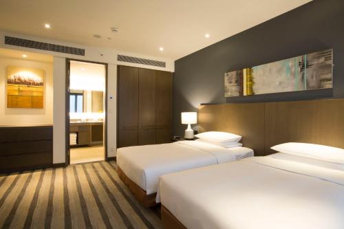 A bed or beds in a room at Hyatt House Shanghai New Hongqiao