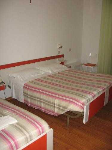 a bedroom with a large bed and two tables at Hotel Prati in Castrocaro Terme