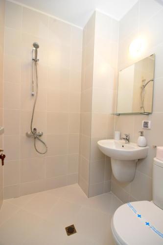 a bathroom with a shower and a toilet and a sink at KATERINA guest house in Kocherinovo