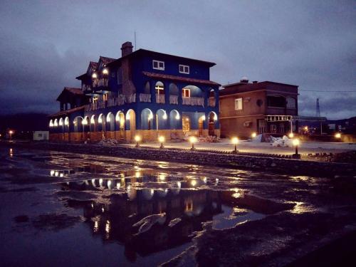 a large building with lights in the water at night at Fly Inn 飛旅宿 in Dongshan