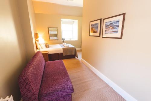 a living room with a couch and a table at Raasay House Hotel in Raasay