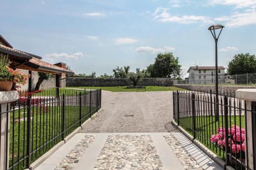 a gate with a stone walkway in a yard at Al Sa di Te in Udine