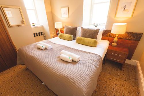a bedroom with a bed with two towels on it at Raasay House Hotel in Raasay