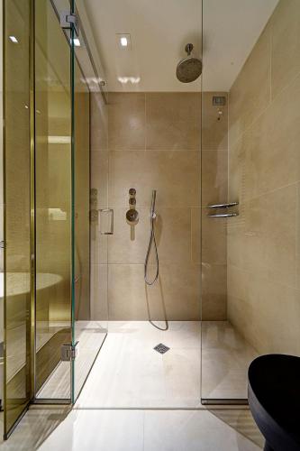 a shower with a glass door in a bathroom at ME Milan Il Duca in Milan