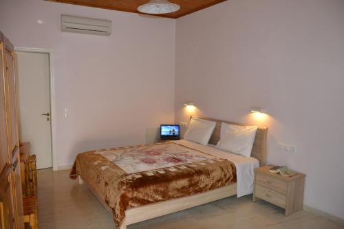 a bedroom with a bed with a laptop on it at Geroulis Stefanos Studios in Vasiliki