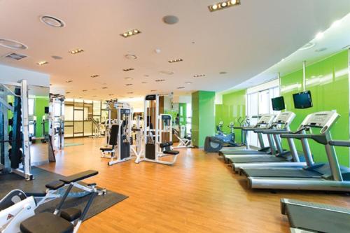 a gym with a bunch of treadmills and machines at Jeongseon Mayhills Resort in Jeongseon