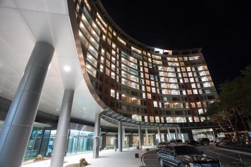 a large building with cars parked in a parking lot at Jeongseon Mayhills Resort in Jeongseon