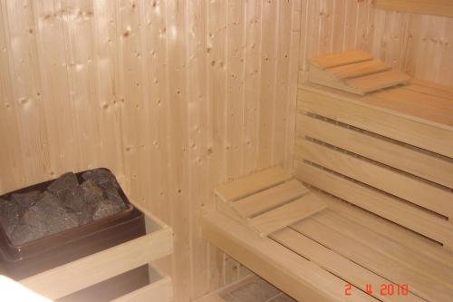 a sauna with wooden steps in a wooden wall at Vila Rila Samokov in Samokov