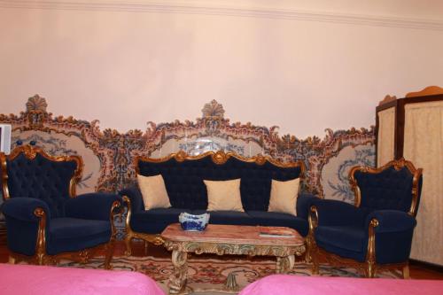 a room with a couch and two chairs and a table at Casa D. Diogo in Arraiolos