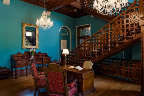 a blue room with a desk and a staircase at Cahernane House Hotel in Killarney