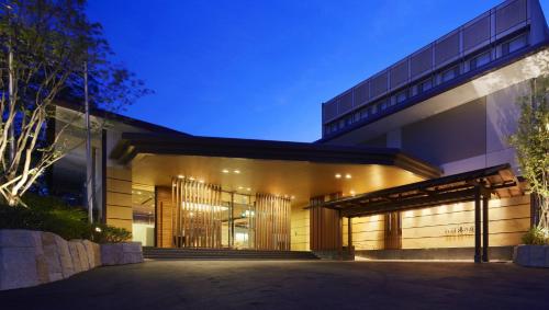 an exterior view of a building at night at Laforet Ito Onsen Yunoniwa in Ito