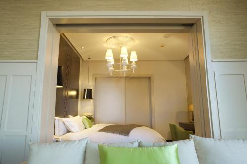 a bedroom with a bed and a large mirror at Sofitel Montevideo Casino Carrasco & Spa in Montevideo