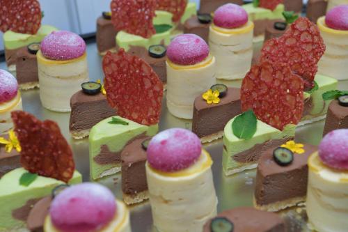 a group of cakes and desserts on a table at Best Western Queens Hotel Pforzheim-Niefern in Pforzheim