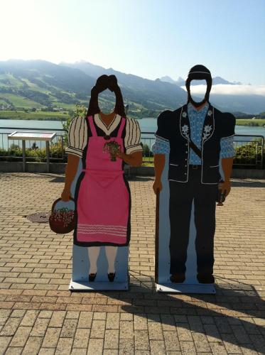 two statues of a man and a woman wearing masks at Motel de la Gruyère Restoroute in Avry devant Pont