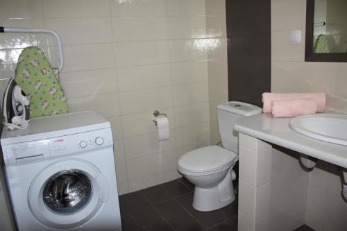 a bathroom with a washing machine and a sink at Vetsa's Experience in Tolo