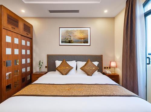 En eller flere senge i et værelse på Mercury Boutique Hotel & Apartment Da Nang
