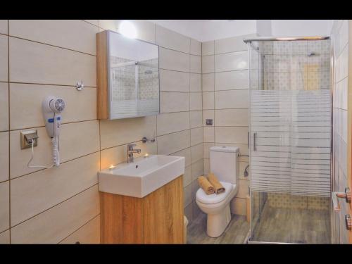 a bathroom with a sink and a toilet at Pan Mare in Skala Sotiros