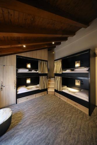 a room with three bunk beds in it at Downtown Boutique Hostel in Zadar