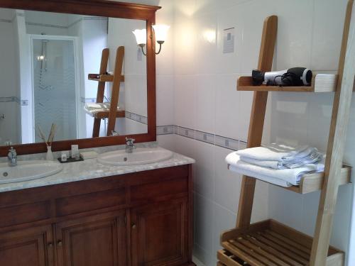 a bathroom with two sinks and a large mirror at GUTKOWSKI Jacqueline in Saint-Philbert-de-Bouaine
