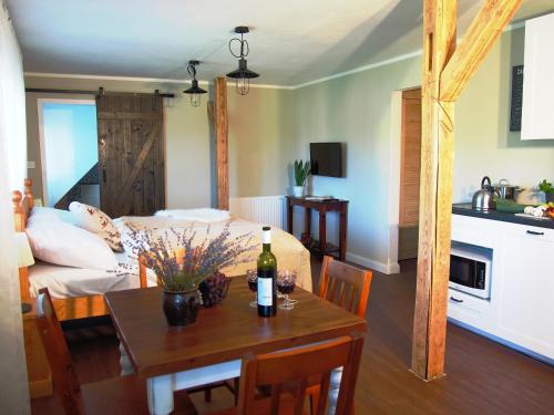 a living room with a table and a room with a couch at Penzion V peřině in Trojanovice
