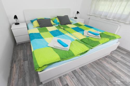 a bedroom with a bed with towels on it at Emerald Soca Apartment in Tolmin