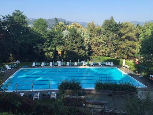 a large swimming pool with chairs at Blue Garden in Rapallo