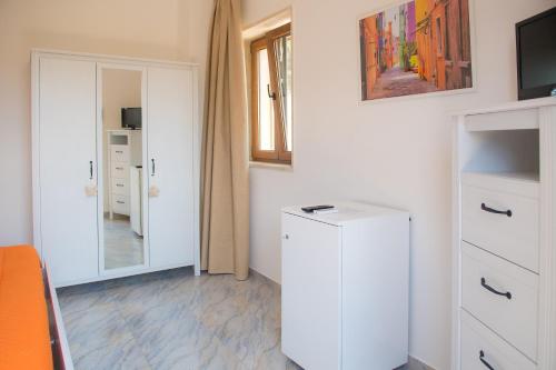 a room with a white cabinet and a mirror at Hotel San Giovanni in Polignano a Mare