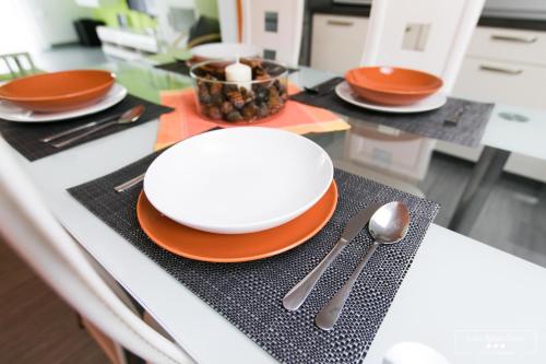 a table with plates and utensils on a counter at Emerald Soca Apartment in Tolmin