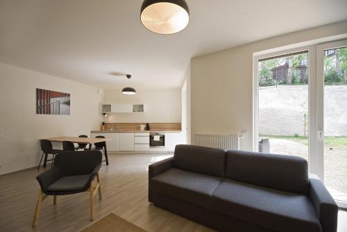a living room with a couch and a table at Lakepark Residence in Staré Splavy