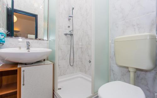 a bathroom with a shower and a toilet and a sink at Studio Apartman MIJA 1 in Malinska